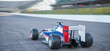 © Chris Ryan/Caia Image - Formula one race car on sports track
