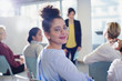 © Sam Edwards/Caia Image - Portrait smiling, confident businesswoman turning, looking back in conference audience