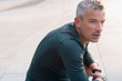 © Martin Barraud/Caia Image - Male runner resting, looking away