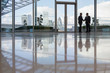 © Martin Barraud/Caia Image - Businessmen handshaking in highrise office urban city view, London, UK