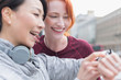 © Martin Barraud/Caia Image - Smiling female runners checking smart watch