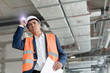 © Rafal Rodzoch/Caia Image - Foreman with flashlight at construction worker