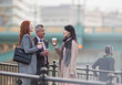 © Martin Barraud/Caia Image - Business people drinking coffee and talking on urban ramp