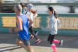 © Martin Barraud/Caia Image - Runners running on sunny urban bridge sidewalk