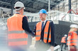© Agnieszka Olek/Caia Image - Male engineers handshaking at construction site