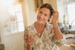 © Sam Edwards/Caia Image - Portrait smiling mature woman drinking white wine in kitchen