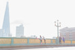 © Martin Barraud/Caia Image - Runners running stretching on sunny, foggy urban bridge, London, UK