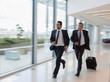© Martin Barraud/Caia Image - Businessmen running, rushing with suitcase in airport