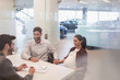 © Martin Barraud/Caia Image - Car salesman talking to pregnant couple in car dealership office