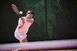 © Chris Ryan/Caia Image - Young male tennis player playing tennis, hitting the ball on sunny tennis court