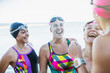 © Caiaimage/Sam Edwards/Caia Image - Laughing female open water swimmers talking