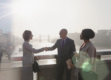 Silhouette Business People Handshaking On Sunny Urban Bridge Over Thames River, London, UK