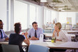 © Sam Edwards/Caia Image - Business people talking at table in shared workspace