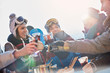 © Agnieszka Olek/Caia Image - Skier friends toasting cocktail glasses apres-ski