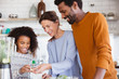 © Sam Edwards/Caia Image - Multi-generation family preparing healthy green smoothie in kitchen