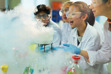 Surprised, Curious Students Watching Chemical Reaction, Conducting Scientific Experiment In Laboratory Classroom