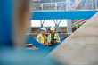 © Agnieszka Olek/Caia Image - Male engineers using digital tablet in factory