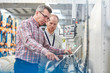 © Agnieszka Olek/Caia Image - Male supervisor and worker examining machinery in fiber optics factory