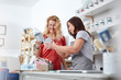 © Agnieszka Olek/Caia Image - Smiling female business owner helping customer choose paint in art shop