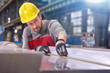 © Agnieszka Olek/Caia Image - Focused male worker examining steel in factory
