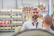 © Lukasz Olek/Caia Image - Serious male supervisor listening to worker in fiber optics factory