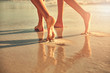 © Trevor Adeline/Caia Image - Bare feet of women walking on wet sand on sunny summer beach