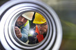 © Lukasz Olek/Caia Image - Serious male engineers with flashlights examining steel pipe