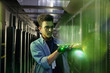 © Agnieszka Olek/Caia Image - Male IT technician holding glowing futuristic digital tablet in server room