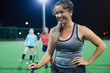 © Sam Edwards/Caia Image - Smiling young female field hockey player on field