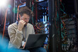 © Agnieszka Olek/Caia Image - Focused male IT technician using laptop in server room