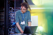 © Agnieszka Olek/Caia Image - Male IT technician working at laptop in server room