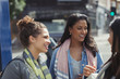 © Caiaimage/Paul Bradbury/Caia Image - Smiling female friends talking on urban street