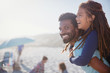 © Sam Edwards/Caia Image - Portrait happy father piggybacking daughter on sunny summer beach