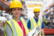 © Sam Edwards/Caia Image - Portrait confident female supervisor with clipboard in warehouse
