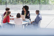 © Caiaimage/Martin Barraud/Caia Image - Businesswoman talking at laptop in conference room meeting