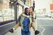 © Caiaimage/Paul Bradbury/Caia Image - Playful young couple piggybacking on urban street