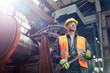 © Agnieszka Olek/Caia Image - Confident male worker holding wrench in factory