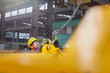 © Rafal Rodzoch/Caia Image - Male factory worker attaching chain to equipment