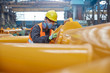 © Agnieszka Olek/Caia Image - Steel worker wearing protective face mask, examining equipment in steel factory