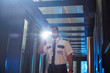© Agnieszka Olek/Caia Image - Male security guard with flashlight in server room