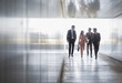 © Caiaimage/Martin Barraud/Caia Image - Business people walking and talking in office corridor