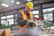 © Rafal Rodzoch/Caia Image - Male worker assembling steel part in factory