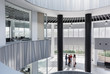 © Caiaimage/Martin Barraud/Caia Image - Business people talking in architectural, modern office atrium