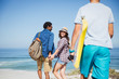 © Sam Edwards/Caia Image - Family walking with boogie board on sunny summer ocean beach