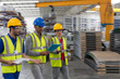 © Sam Edwards/Caia Image - Supervisor and workers with clipboard and digital tablet walking in factory