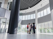 © Caiaimage/Martin Barraud/Caia Image - Business people talking in architectural, modern office lobby