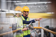 © Martin Barraud/Caia Image - Male supervisors with clipboard talking on platform in factory
