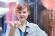 © Rafal Rodzoch/Caia Image - Female IT technician holding futuristic digital tablet in server room