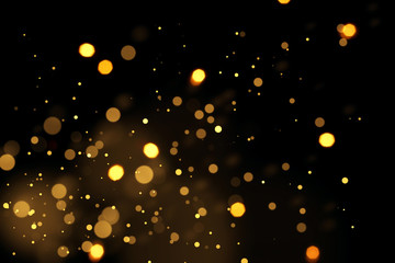 Golden defocused lights over black background