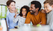 © Sam Edwards/Caia Image - Smiling multi-ethnic family drinking healthy green smoothie in kitchen